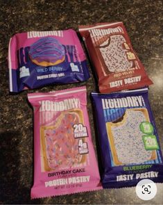 three bags of birthday cake candy sitting on top of a granite countertop next to each other