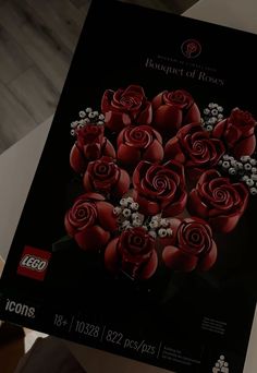 a large box of legos with red roses in it