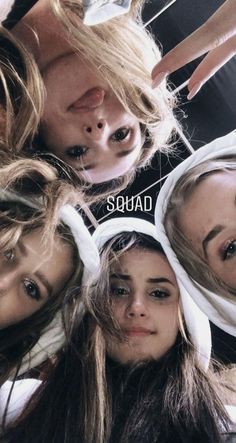 four girls with their heads wrapped around each other and the words squad written on them