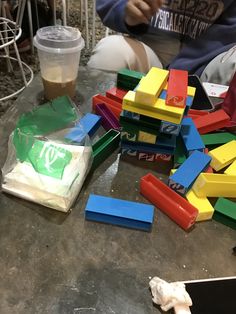 there are many different colored blocks on the table and one has a plastic bag in front of it