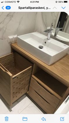 a bathroom vanity with two drawers and a sink in the middle, next to a mirror