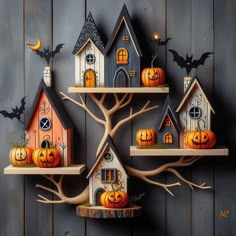 halloween decorations are displayed on wooden shelves with bats and jack - o'- lanterns