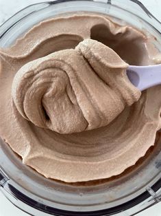 a spoon is in a bowl filled with chocolate frosting and some sort of icing