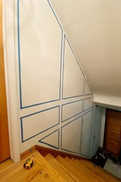 an unfinished room with blue lines painted on the wall and wood flooring under it