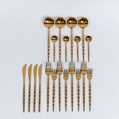 a group of gold colored forks and spoons