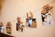 several pictures hanging on a string with clothes pins and magnets attached to them in the shape of letters