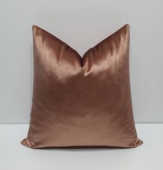 a brown pillow sitting on top of a white table