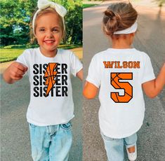 two girls wearing matching shirts that say sister and sister 23 on the same t - shirt