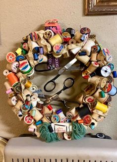 a pair of scissors sitting on top of a table next to a pile of buttons