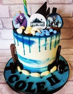 a blue and white cake decorated with fortnite items