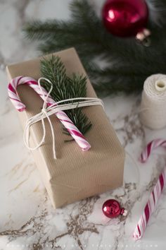 a present wrapped in brown paper with candy canes