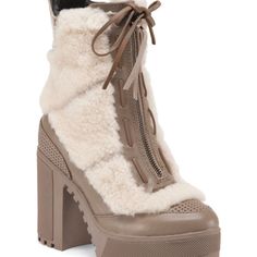 Apron Almond Cap Toe - Leather And Genuine Shearling Upper (Beige Only) - Laced-Up Vamp With Bow - Front And Back Perforated Detail - Front Zip Closure - Lightly Padded Footbed - Platform Block Heel - Lug Sole - Approx. 7.5" Shaft Height, 11.5" Opening Circumference - Approx. 4" Heel, 1.5” Platform - Imported Wool Detail, Lug Sole, Textures Heel, Platform Style 4in. Heel 6.5in. Shaft Heigh Luxury Winter Boots With Faux Fur Trim, Beige Shearling Boots For Fall, Beige Sheepskin Boots For Winter, White Sheepskin Boots For Winter, Cream Leather Winter Boots, White Sheepskin Winter Boots, Beige Sheepskin Winter Boots, Cream Shearling Boots For Winter, Cream Leather Boots For Winter