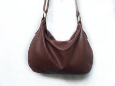 Leather medium hobo bag made with brown soft leather. The bag is closed with a metallic zip. Inside is unlined and there is a large cotton zipped pocket. There is an adjustable shoulder strap made with stronger brown leather. Features : - Brown leather, - Zipped bag, - Unlined, - Inside cotton zipped pocket, Size: - Height 10 inch, - Lenght 14 inch, - Shoulder belt is adjustable, min 24/max 47 inch. Contact me for any information --------------------------------------- The shipping is made after Versatile Brown Hobo Bag With Leather Lining, Brown Textured Leather Hobo Shoulder Bag, Brown Satchel Hobo Bag With Handle Drop, Simple Leather Bag, Suede Hobo Bag, Favorite Purse, Shoulder Belt, Hobo Bags, Brown Leather Bag