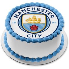 a manchester city cake with blue icing and white frosting on the bottom layer