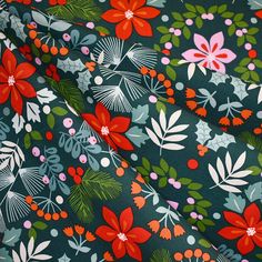 the fabric is green with red flowers and leaves on it's side, while the background