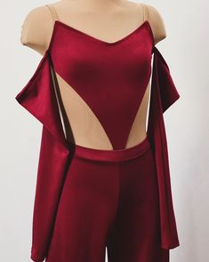 a mannequin wearing a red top with cutouts on the shoulders and sides