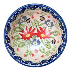 a blue and white bowl with red flowers on it