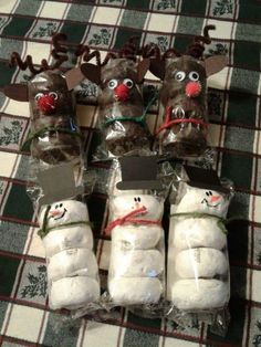 stuffed snowmen are wrapped in plastic bags with reindeer hats and noses on their heads