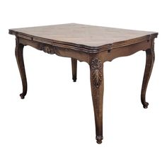 an old style wooden table with carvings on the top and legs, isolated against a white background