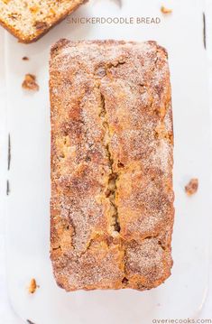 a loaf of bread sitting on top of a white cutting board