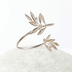 "Natural Olive leaf bracelet, Ancient Greek Olive Branch Bracelet, Greek Jewelry, Delicate Bangle Bracelet, Gift for her This item will be shipped by DHL Express. Free Shipping for orders over 100€! Europe Transit Time : 1-2 working days / All other countries Transit Time: 2-3 working days. This bracelet is part of an Olive collection, inspired by by the olive leaf symbol, a symbol of peace and prosperity. This beautiful bracelet is adjustable and is slid on to the wrist. Elegant and unique gift Olive Branch Jewelry, Greece Jewelry, Ancient Greek Ring, Greek Bracelet, Ancient Bracelet, Branch Jewelry, Branch Bracelet, Leaf Symbol, Leaves Jewelry