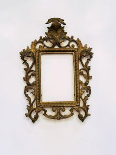 an ornate gold frame hanging on the wall