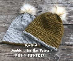 two knitted hats with white and brown pom - poms sitting on wooden planks