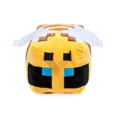 a small yellow minecraft pillow with some white paper on it's head and eyes