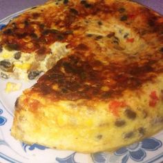 a close up of a slice of pizza on a blue and white plate with flowers