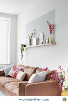 a living room filled with furniture and flowers