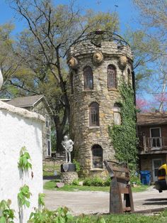 an old stone tower sitting in the middle of a yard