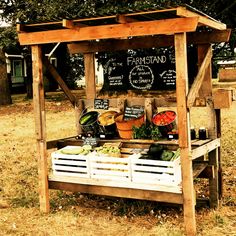 an outdoor produce stand with vegetables and fruits