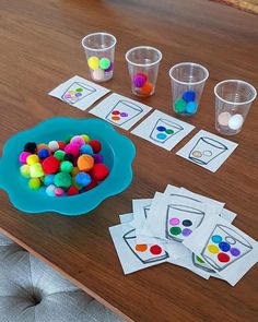 the table is set up with cups and cards to help children learn colors in their homeschool