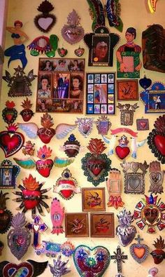 a wall covered in lots of different shaped and colored magnets with pictures on them