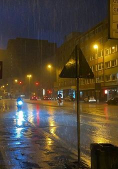 a city street at night in the rain