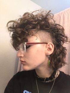 Short Punk Hairstyles For Curly Hair, Curly Shaved Mullet, Curly Shaved Sides Mullet, Short Curly Mullet Shaved Sides, Curly Hair Mohawk Women, Curly Fohawk Haircut, Mohawk Down, Mullet With Shaved Sides Curly Hair, Short Curly Punk Hair