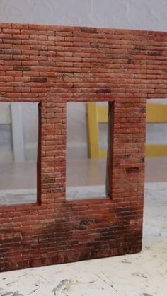 a red brick building with two windows on the front and one window in the back