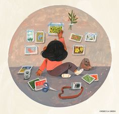 a child is sitting on the floor surrounded by pictures and other things that are scattered around