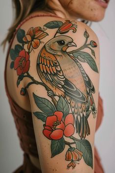 a woman's arm with a bird on it and flowers around the arm area