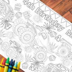 a birthday coloring page with crayons and markers on a wooden table next to it