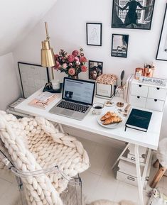 a white desk topped with a laptop computer