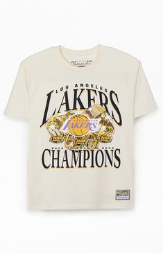 Treat yourself to a fresh pick from Mitchell & Ness with the new  Los Angeles Lakers Champions T-Shirt. This retro tee has a bold vibe with printed graphics on the front, a comfortable crew neckline, short sleeves, regular fit, and woven Hardwood Classics tag at the left hem.   	Crew neckline 	Short sleeves 	Standard fit 	Front graphic 	100% Cotton 	Machine washable Cream Cotton T-shirt With Graphic Print, Cream Screen Print Crew Neck T-shirt, Cream Crew Neck T-shirt With Screen Print, Cream Logo Print Top For Streetwear, Cream Screen Print T-shirt For Streetwear, Vintage College Tee, Cream Graphic Print Top For Streetwear, Cream T-shirt With Text Print For Streetwear, Cream Text Print T-shirt For Streetwear