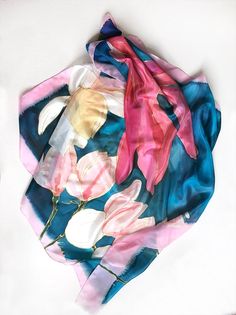 Square silk scarf- Magnolia's song/ Petroleum blue and pink scarf painted by hand/ Floral scarf/ Hand painted scarf/ Lightweight scarf ooak/ Women accessory blue/ Summer fashion scarf/ Blue, pink scarf with floral motif/ Unique handmade scarf/ Silk painting by Klara The silk has been painted with reactive dye that becomes part of the silk during the steaming process. They're colorfast and will last a lifetime. ►Wash by hand only! Wash in cold water! ►dimension 35'x35' Magnolias scarf painted on Artistic Hand Dyed Blue Silk Scarf, Artistic Blue Silk Scarf For Spring, Handmade Pink Silk Scarf, Artistic Pink Silk Scarf For Summer, Artistic Handmade Blue Silk Scarf, Pink Hand Painted Silk Scarves, Pink Hand Painted Silk Scarf As Gift, Pink Artistic Scarves For Summer, Hand Painted Pink Silk Scarf For Gift