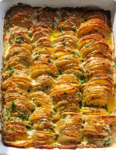 a casserole dish with potatoes and parsley in the middle, ready to be eaten