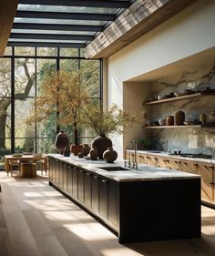 a kitchen with large windows and lots of counter space