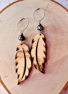 A fun lightweight low-cost collection. These are a "Feather Friday Drop" from a black Friday sale 2024--a fun laser-cut feathers with a double feather twist. Most are engraved with an asymmetrical feather on each pair for a fun unique style. Each feather measures roughly 4 to 5 inches. The longest being "Chief". The wood used was a mix: some are hickory, most are walnut, and a few are cedar. Gourd Jewelry, Farm Jewelry, Wooden Feather, Laser Cut Earrings, Cut Earrings, Wooden Earrings, Wooden Jewelry