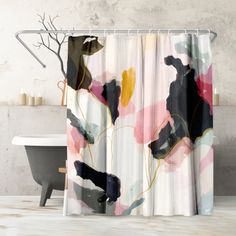 a shower curtain with an abstract flower design on it, next to a bathtub