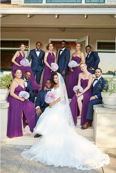 a bride and groom posing with their bridal party in front of a house on the steps