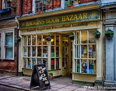 the bagons book bazaar is located in an old brick building with glass doors and windows