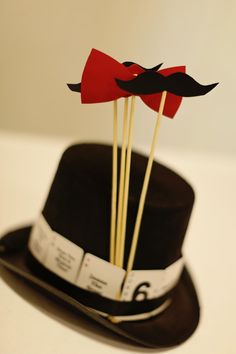 a hat with sticks sticking out of it and two mustaches on top of it